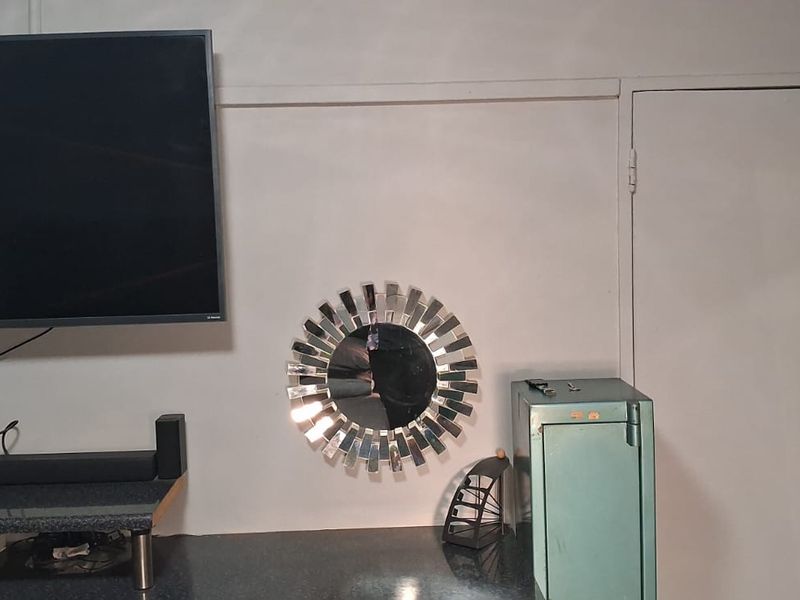 A living area featuring a built-in counter surface and an internal door, providing a functional space for entertainment and storage.