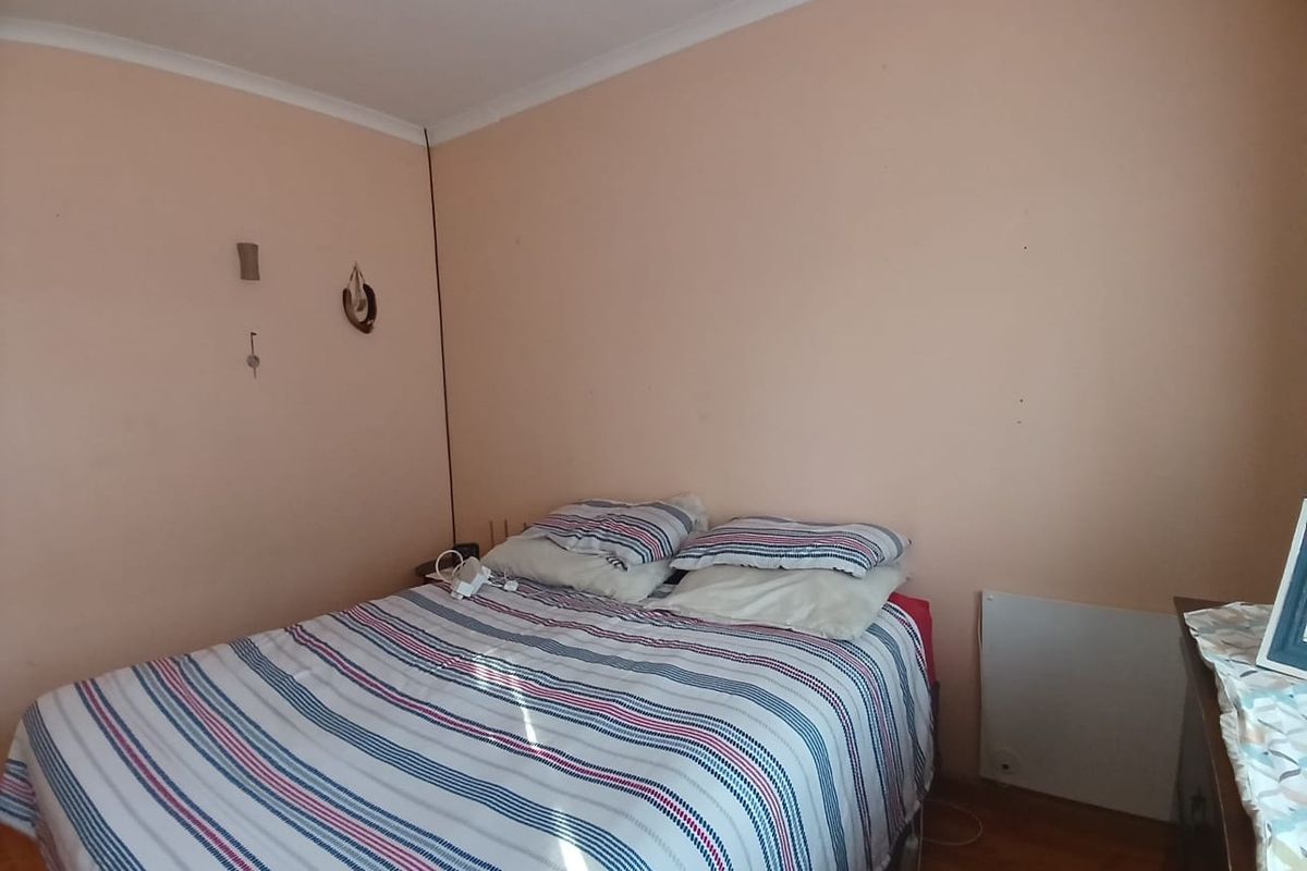 A bedroom featuring plain walls and coving, currently requiring cosmetic updates to improve the overall aesthetic and finish.