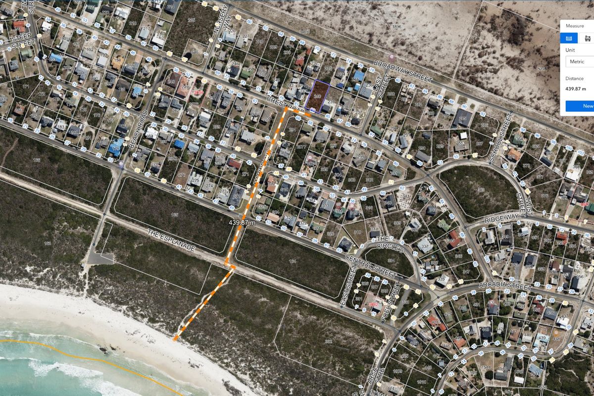 Aerial view of a residential land parcel showing its location and proximity to the coastline and surrounding neighborhood infrastructure.