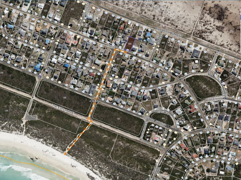 Aerial view of a residential land parcel showing its location and proximity to the coastline and surrounding neighborhood infrastructure.