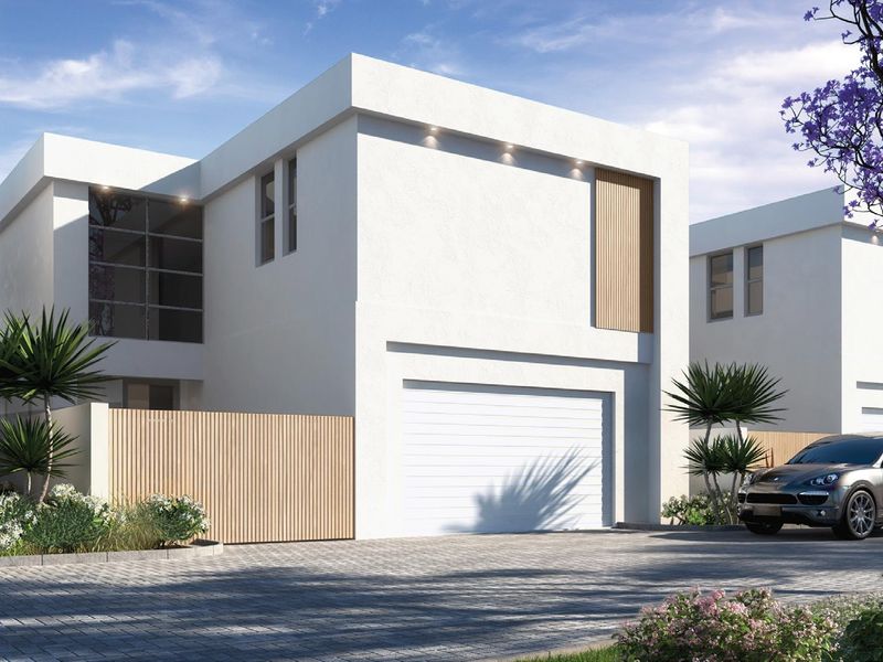 Modern contemporary double-storey house facade featuring clean white render, timber accents, and a secure garage entrance.