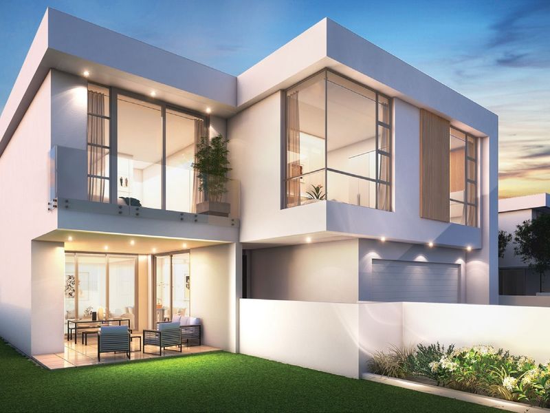 Modern two-story residential exterior featuring a covered patio, glass balcony balustrades, large floor-to-ceiling windows, and a well-maintained garden.