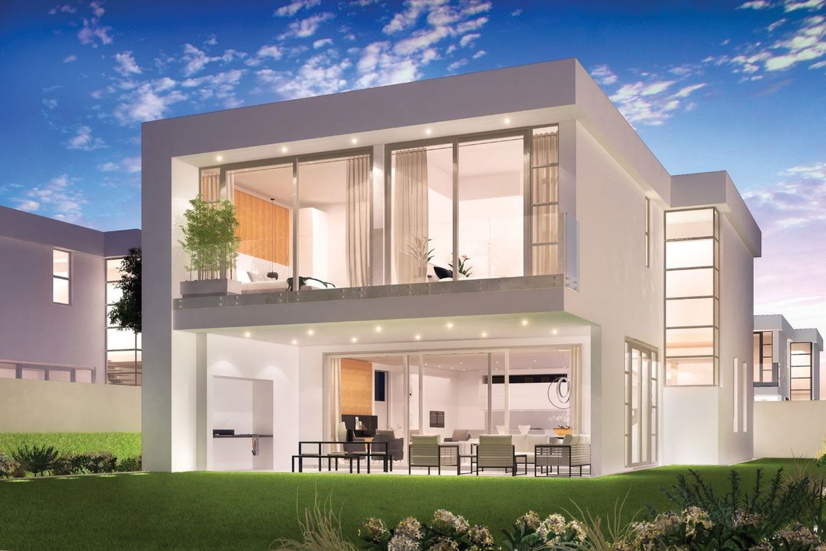 Modern double-story residence featuring expansive glass sliding doors, a spacious balcony with glass balustrade, and a covered patio with built-in outdoor braai area.