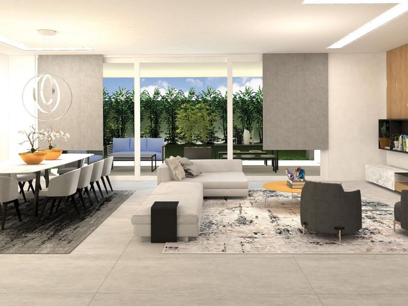 Spacious open-plan living and dining area featuring large format floor tiles, recessed lighting, and seamless access to the outdoor patio through sliding glass doors.