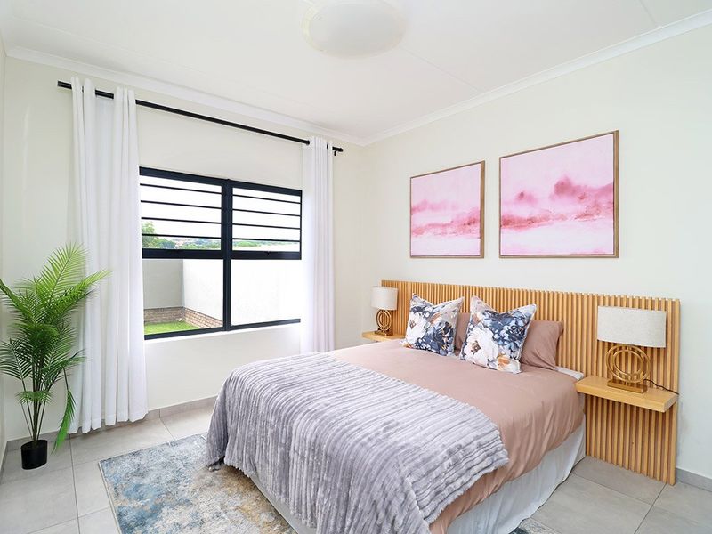 A well-maintained bedroom featuring tiled flooring, a modern slatted timber headboard with integrated bedside shelves, and a black aluminium window frame.