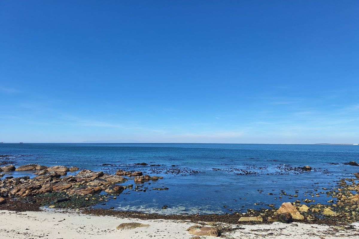 A scenic view of the rocky coastline and ocean, highlighting the natural beauty and waterfront location of the property.