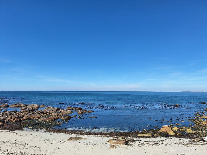 A scenic view of the rocky coastline and ocean, highlighting the natural beauty and waterfront location of the property.