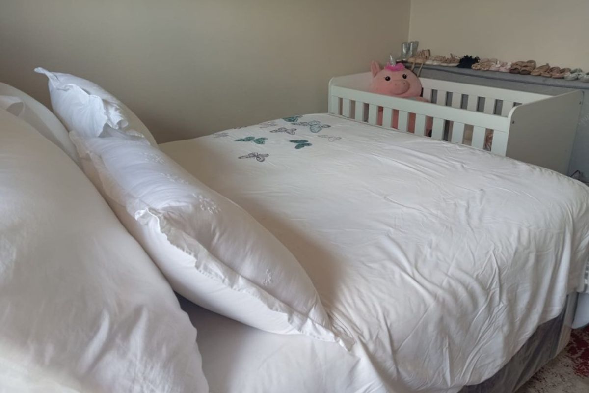 A bedroom featuring neutral wall finishes and standard flooring, currently utilized as a sleeping space.