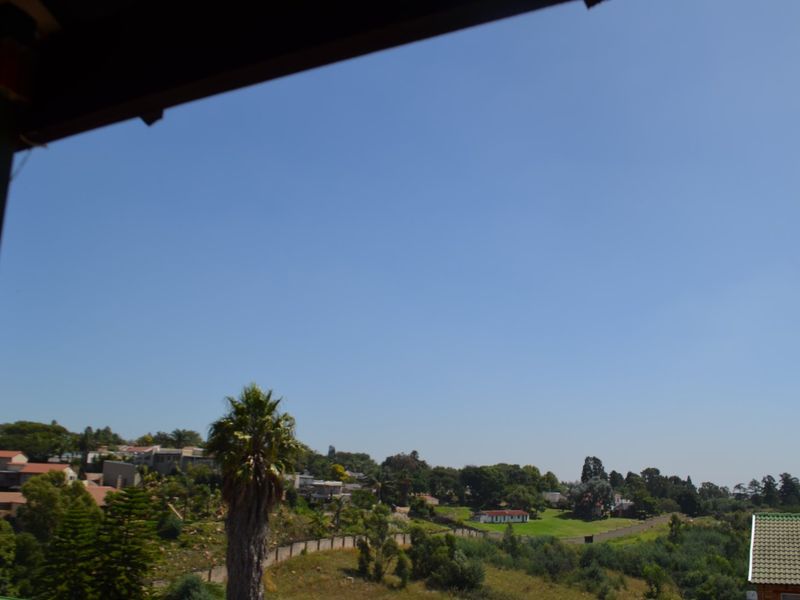 A clear, elevated view overlooking the surrounding residential neighbourhood and green landscape.