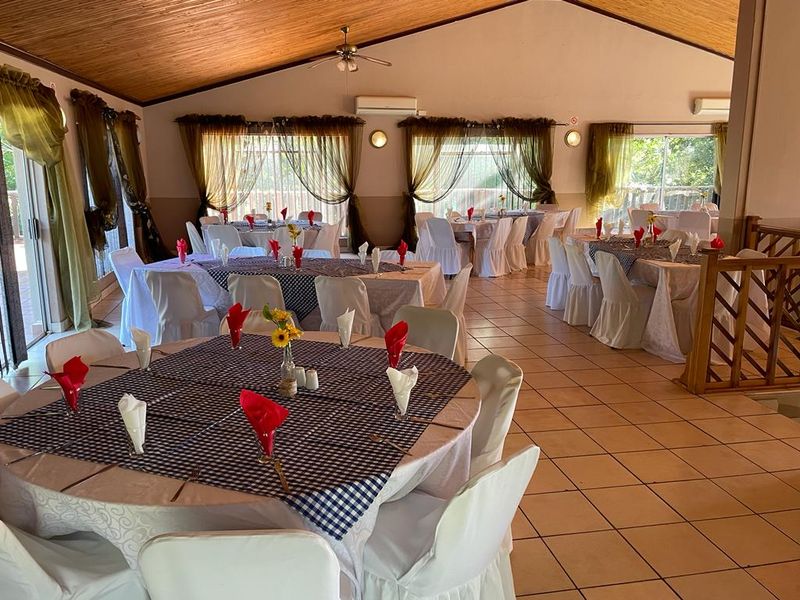 Spacious open-plan area featuring a vaulted timber ceiling, ceramic tiled flooring, and split-system air conditioning, suitable for dining or event hosting.