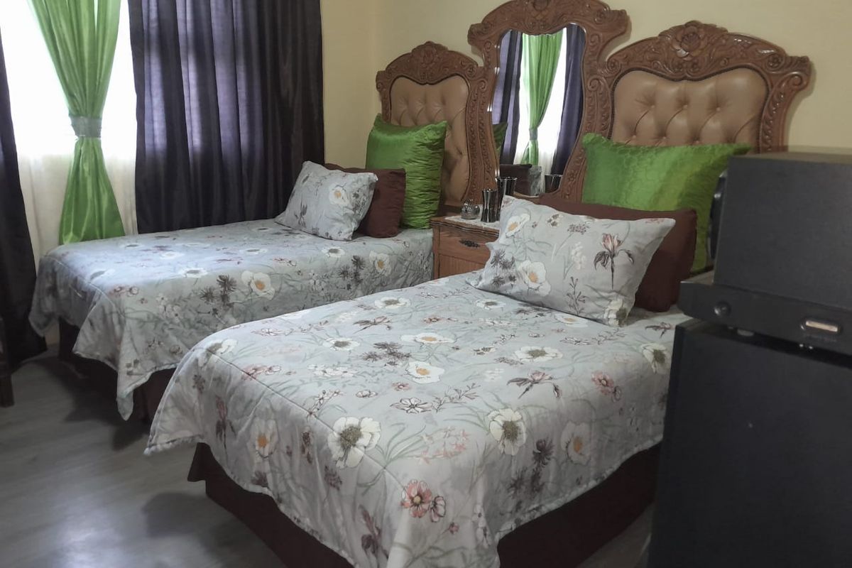 A bedroom featuring laminate flooring and neutral wall finishes.