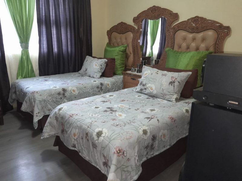A bedroom featuring laminate flooring and neutral wall finishes.