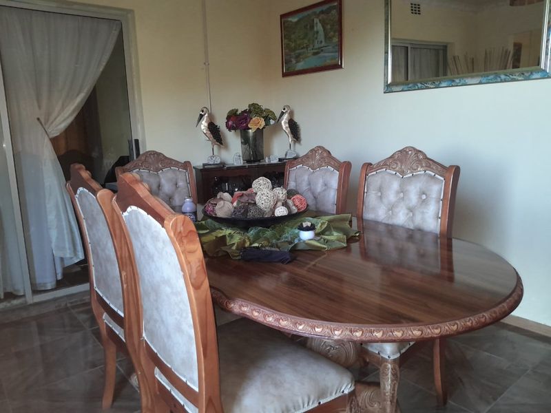 A dining room featuring tiled flooring and a sliding glass door providing access to an adjacent space.