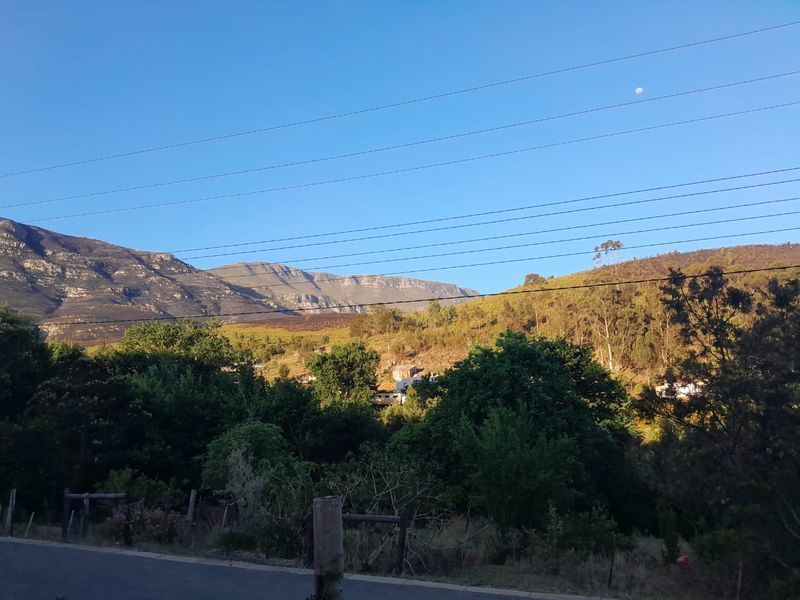 A scenic view of the surrounding mountain landscape and natural vegetation.