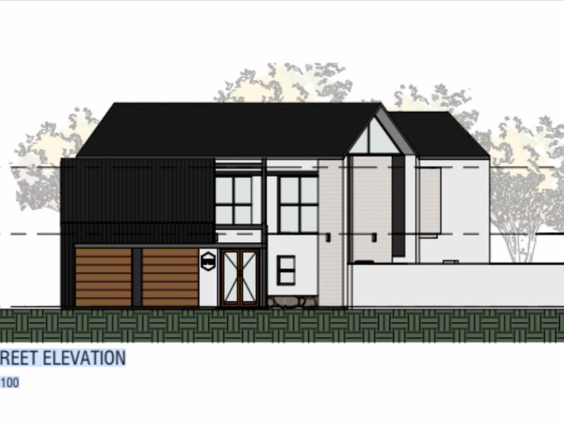 Architectural street elevation drawing showing the proposed facade design, including garage doors, entrance, and window placement for the residential property.