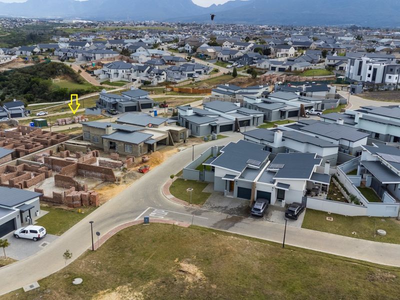 Aerial view of a residential estate development showing completed homes and ongoing construction projects within a suburban neighborhood setting.