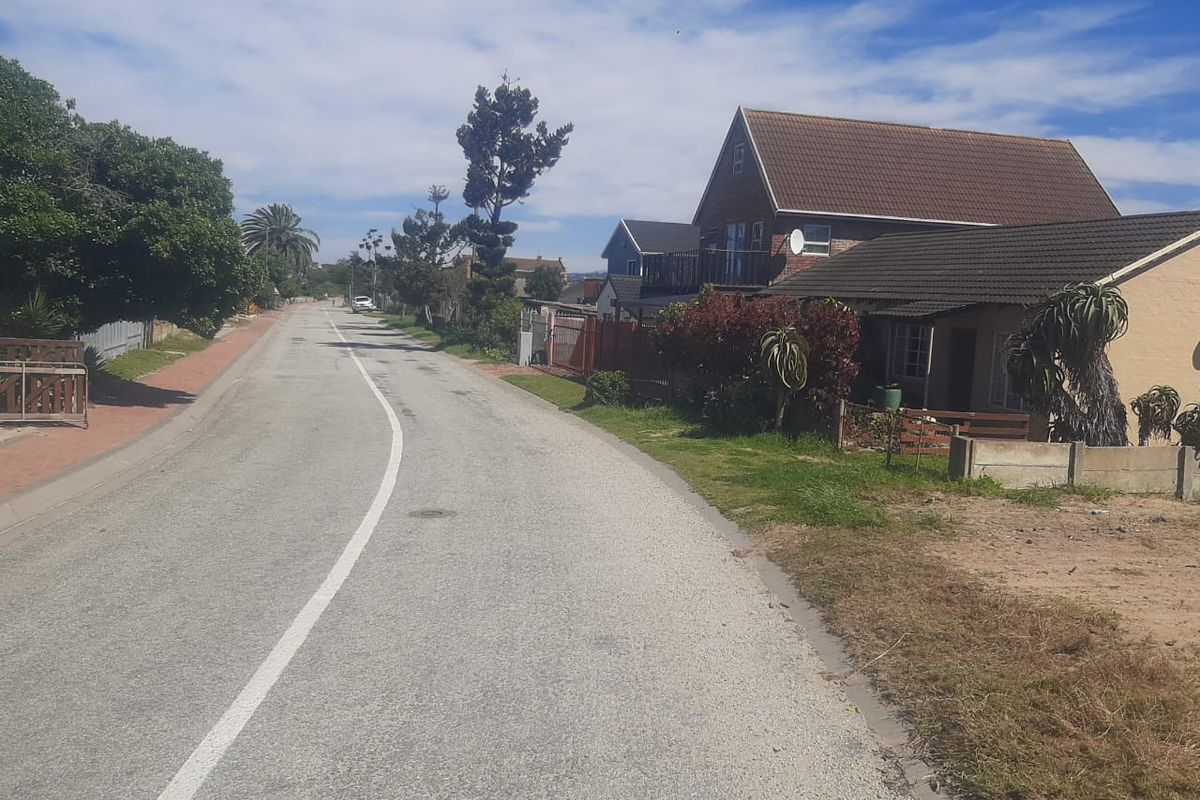 A street view showing the paved road, curbs, and surrounding residential properties in the neighborhood.