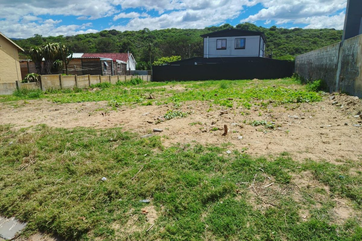 A vacant residential plot featuring a level terrain, enclosed by boundary walls and fencing, offering a clear space for future development.