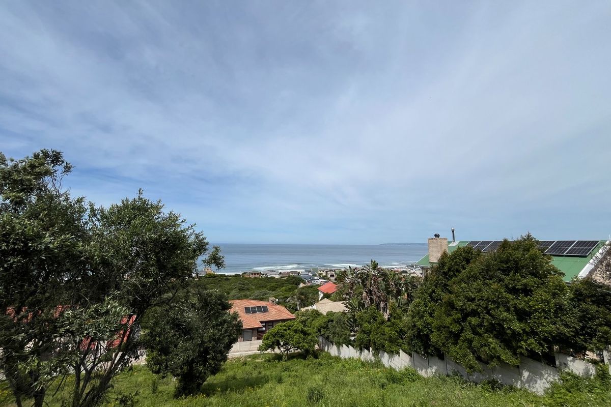 An elevated view overlooking the coastal landscape and ocean, showcasing the natural surroundings of the residential property.