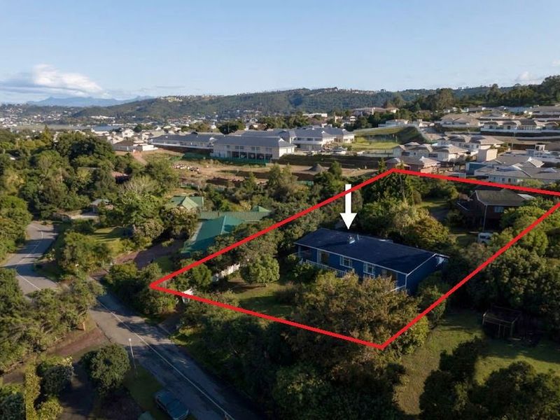 Aerial view of the property highlighting the house and its surrounding garden plot within the residential neighborhood.