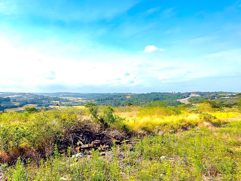 A wide-angle view of the vacant residential land, showcasing the natural landscape and surrounding terrain.