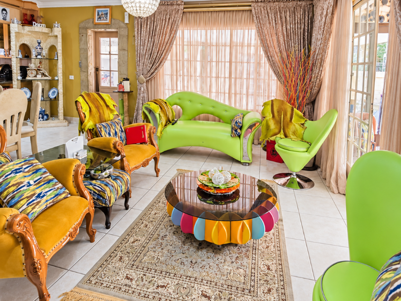 Spacious living room featuring tiled flooring, recessed lighting, and large sliding glass doors that provide ample natural light and access to the outdoors.