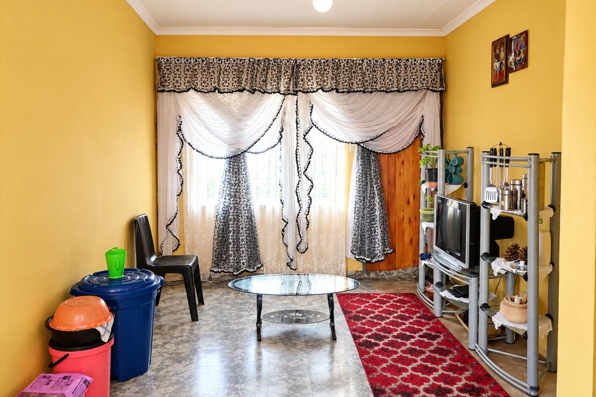 A living room featuring yellow walls, coved ceilings, and vinyl flooring, providing a functional space ready for modern updates and personal styling.