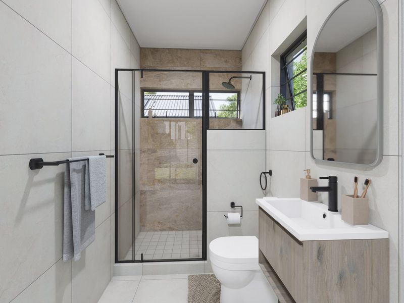 Modern bathroom featuring a walk-in shower with black-framed glass, wall-mounted vanity with basin, and contemporary tiled finishes throughout.