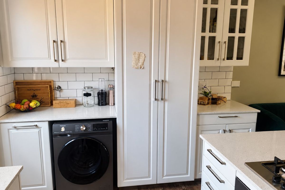 Modern kitchen featuring white shaker cabinetry, subway tile backsplash, quartz countertops, and an integrated washing machine with a built-in gas cooktop.
