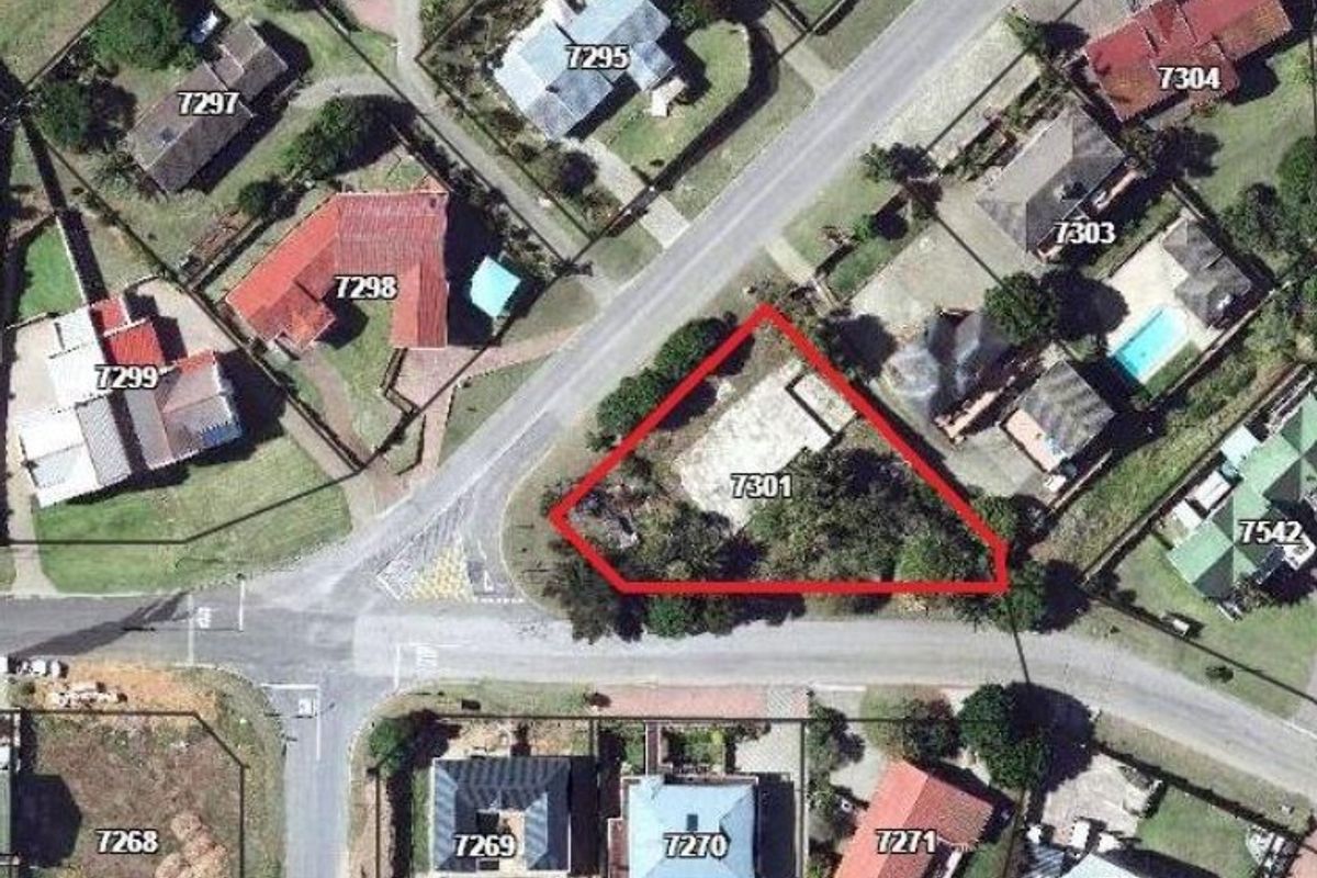 Aerial view of a vacant residential plot highlighted in red, situated within an established suburban neighborhood.