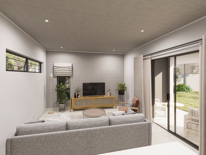 Modern living room featuring an exposed brick accent wall, recessed downlighting, and large sliding glass doors providing seamless access to the outdoor patio area.