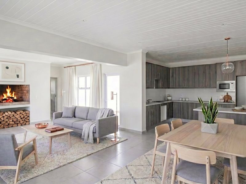A modern open-plan living and kitchen area featuring a built-in fireplace, contemporary timber-look cabinetry, stone countertops, and high-quality tiled flooring throughout.
