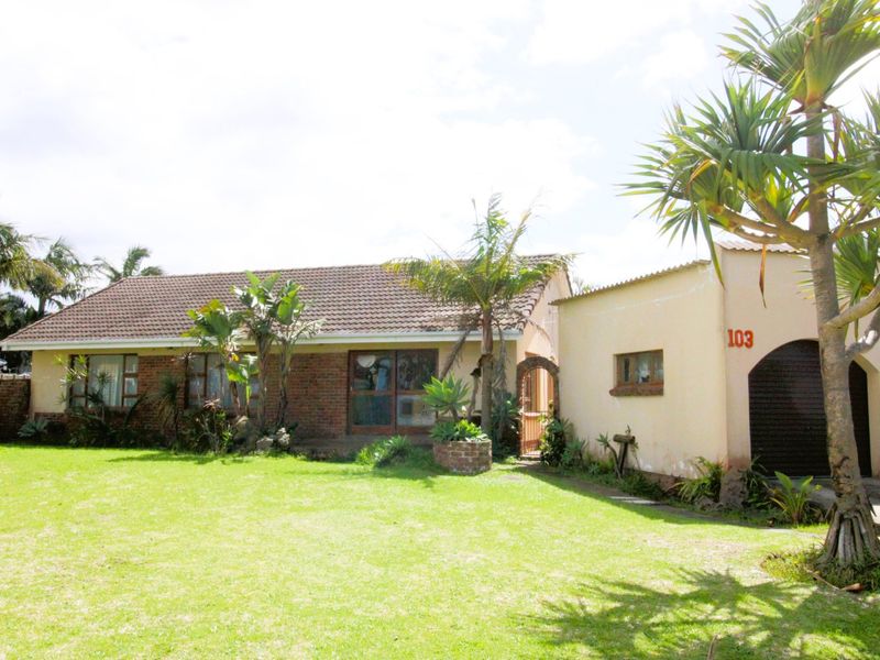Front view of a single-story brick house featuring a tiled roof, attached garage, and a spacious front lawn.