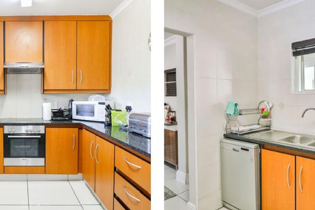 A functional kitchen featuring wooden cabinetry, granite countertops, built-in oven, and tiled finishes, providing a practical workspace with integrated appliance connections.