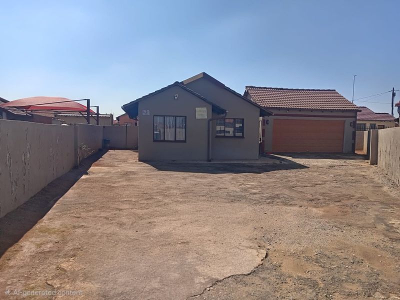 Front view of a single-story house featuring a tiled roof, attached garage, and a large concrete driveway enclosed by boundary walls.