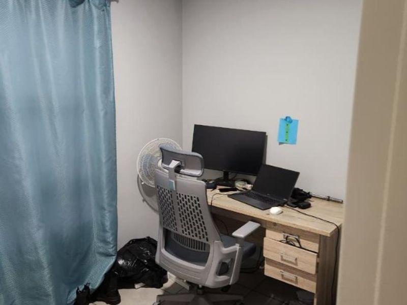 A compact office space featuring neutral wall finishes and tiled flooring, suitable for a home workspace setup.