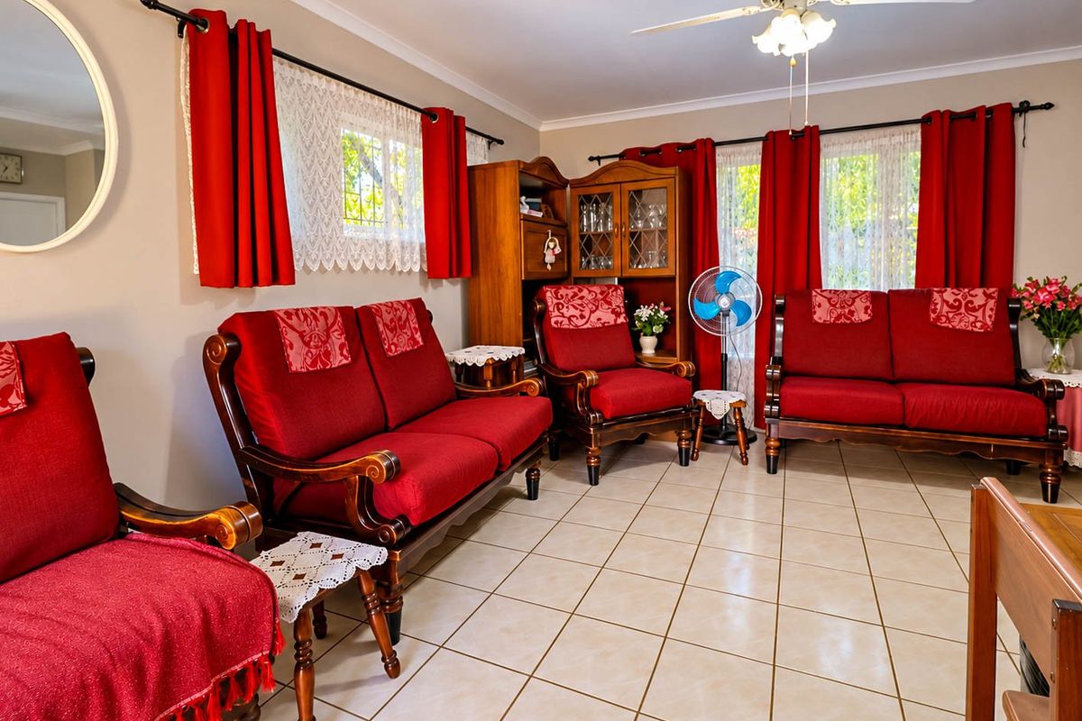 A living room featuring tiled flooring, a ceiling fan, and coved cornicing, providing a functional space with neutral wall finishes.