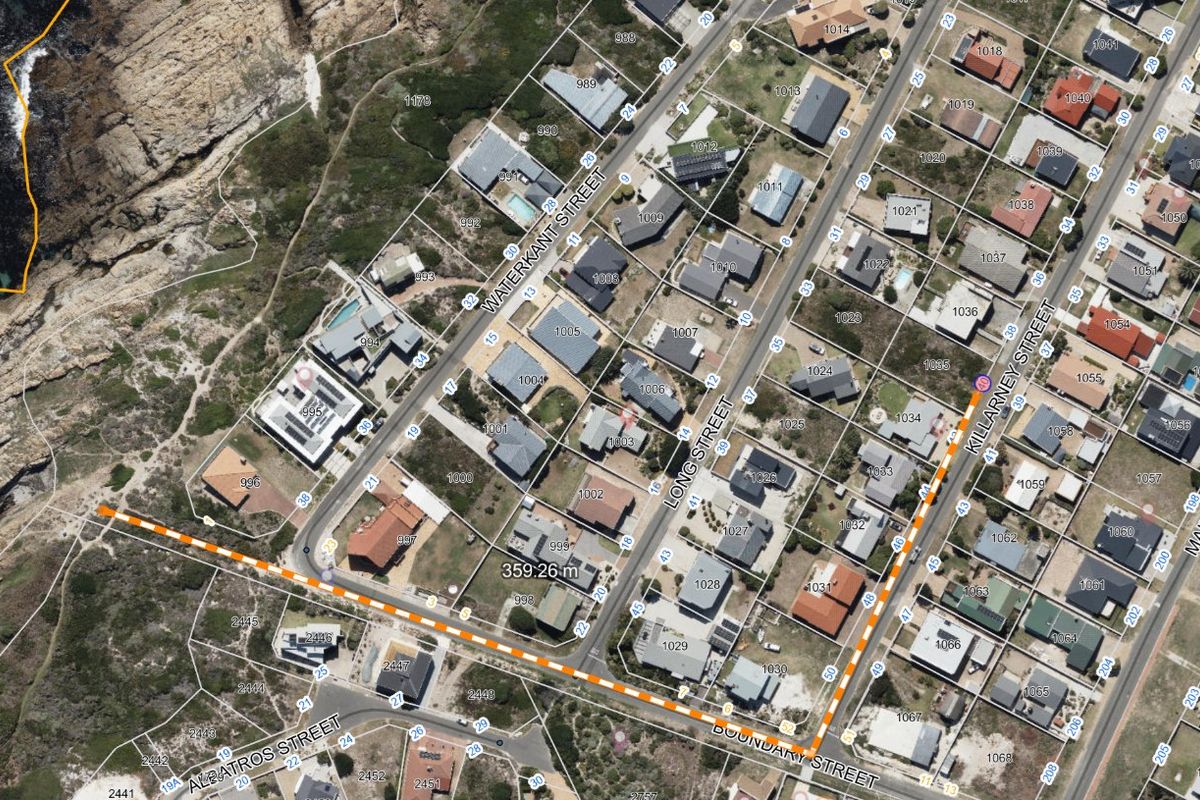An aerial satellite view showing the residential street layout and coastal proximity of the property area.