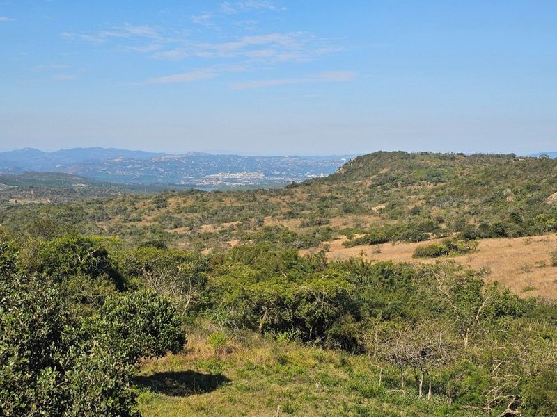 Expansive panoramic view of the surrounding natural landscape, rolling hills, and distant valley scenery.