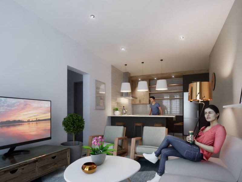 Modern open-plan living area featuring a contemporary kitchen with island, sleek cabinetry, and recessed lighting, creating a cohesive and functional living space.