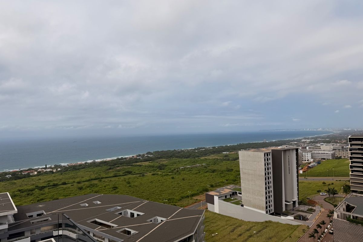 Elevated coastal view overlooking the surrounding landscape, nearby residential developments, and the ocean horizon.