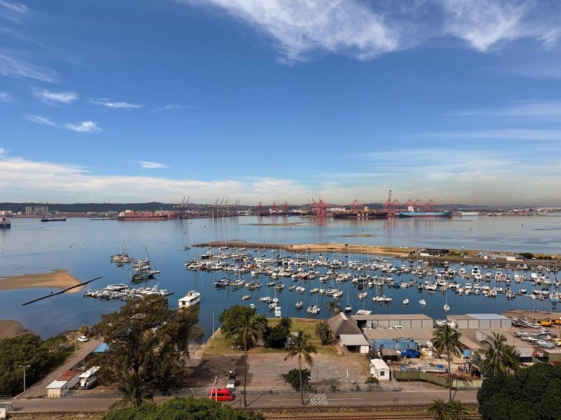 Elevated panoramic view overlooking the marina, harbor, and industrial port area.