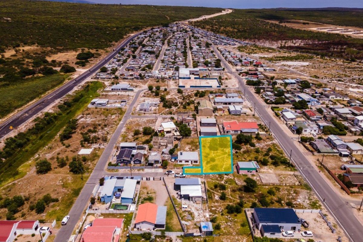 Aerial view of a vacant residential plot in a developed neighborhood, highlighting the property boundaries and surrounding infrastructure.