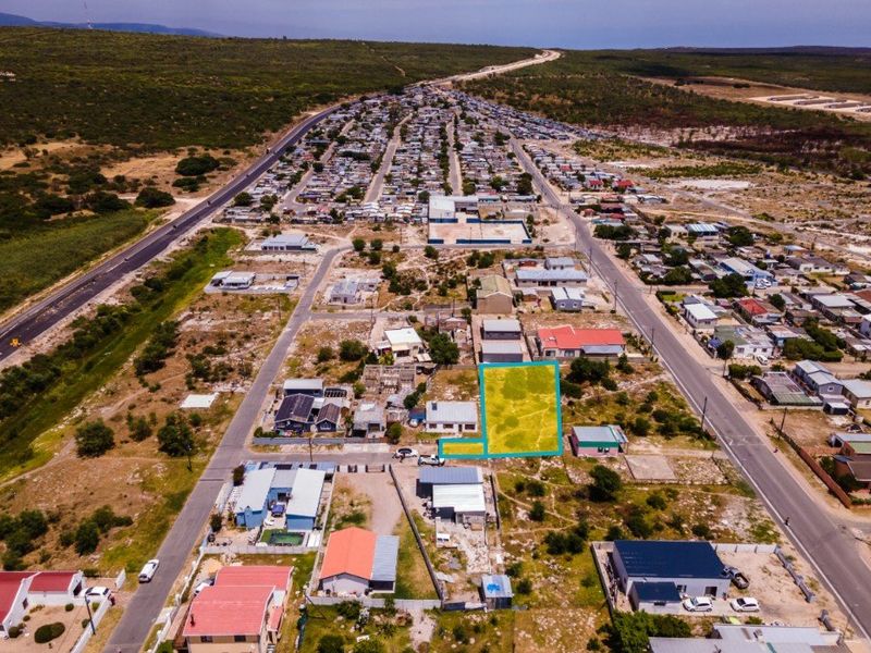 Aerial view of a vacant residential plot in a developed neighborhood, highlighting the property boundaries and surrounding infrastructure.