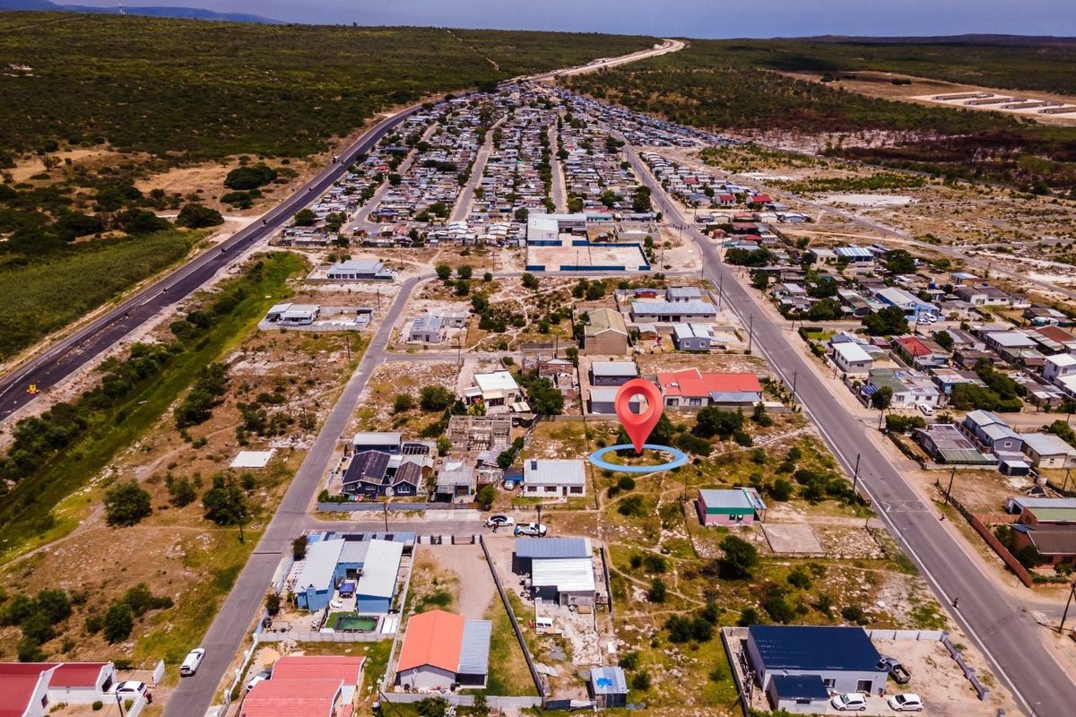 Aerial view of a vacant residential plot located within an established neighborhood, featuring convenient road access and surrounding residential infrastructure.