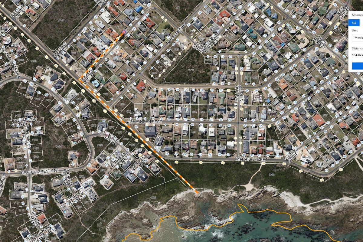 Aerial satellite view showing residential street layout and proximity to the coastline with digital measurement overlays.