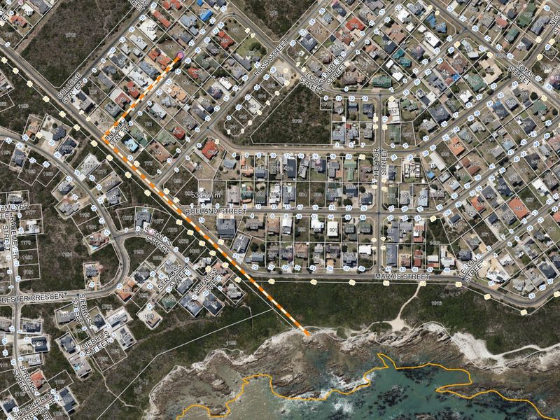 Aerial satellite view showing residential street layout and proximity to the coastline with digital measurement overlays.