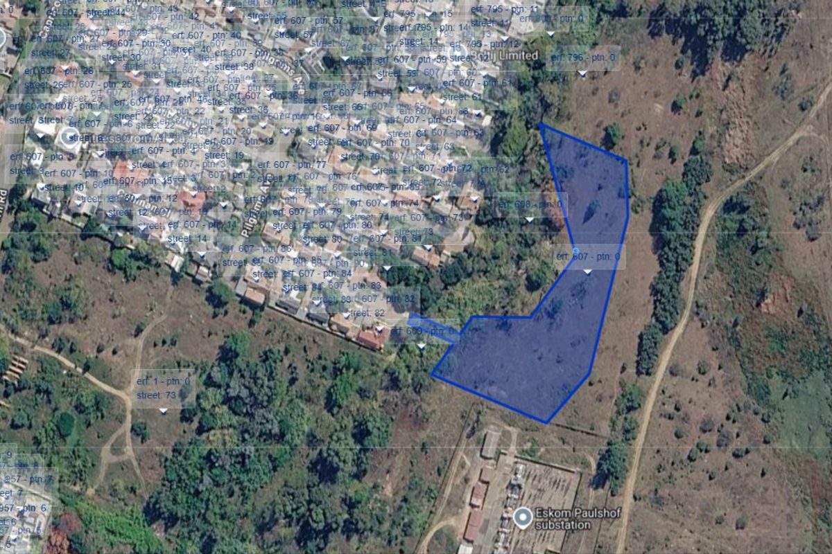 An aerial satellite view showing the boundaries of the vacant residential land plot in relation to the surrounding neighborhood and infrastructure.