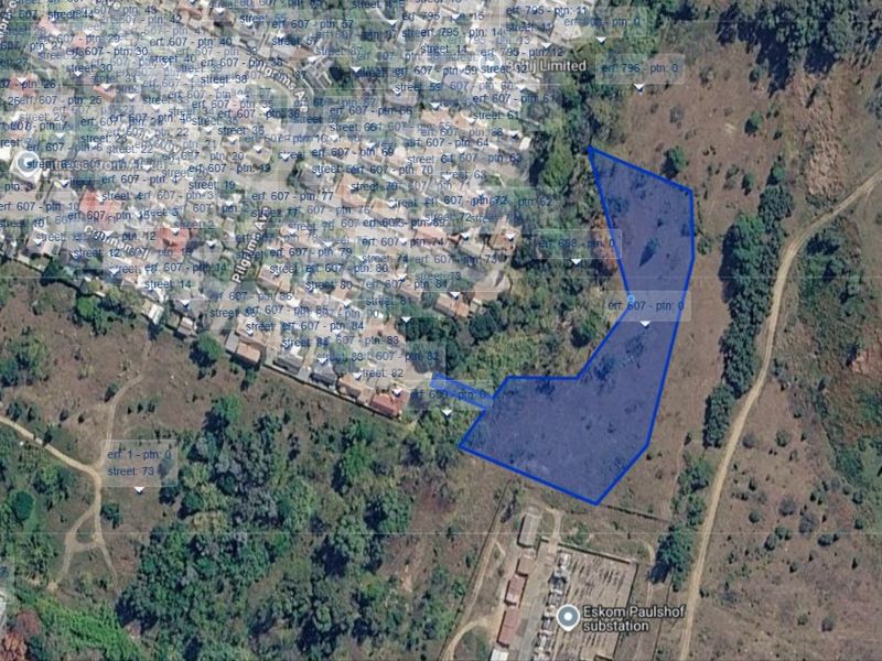 An aerial satellite view showing the boundaries of the vacant residential land plot in relation to the surrounding neighborhood and infrastructure.
