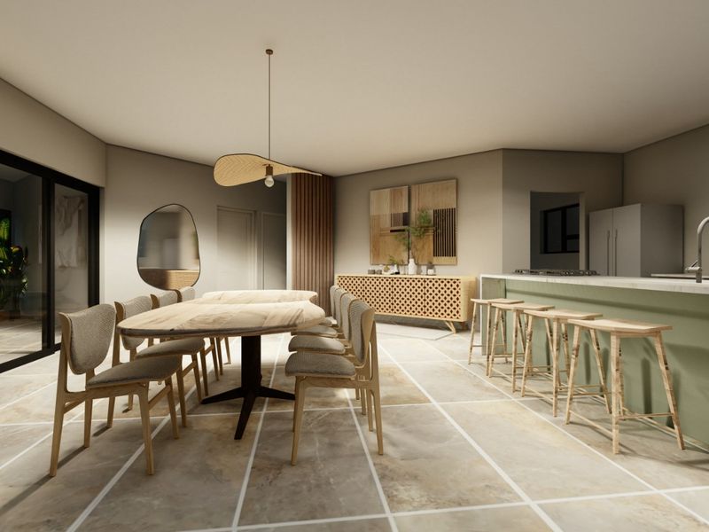 A modern open-plan living and dining area featuring a kitchen island with stone countertops, tiled flooring, and large sliding glass doors.